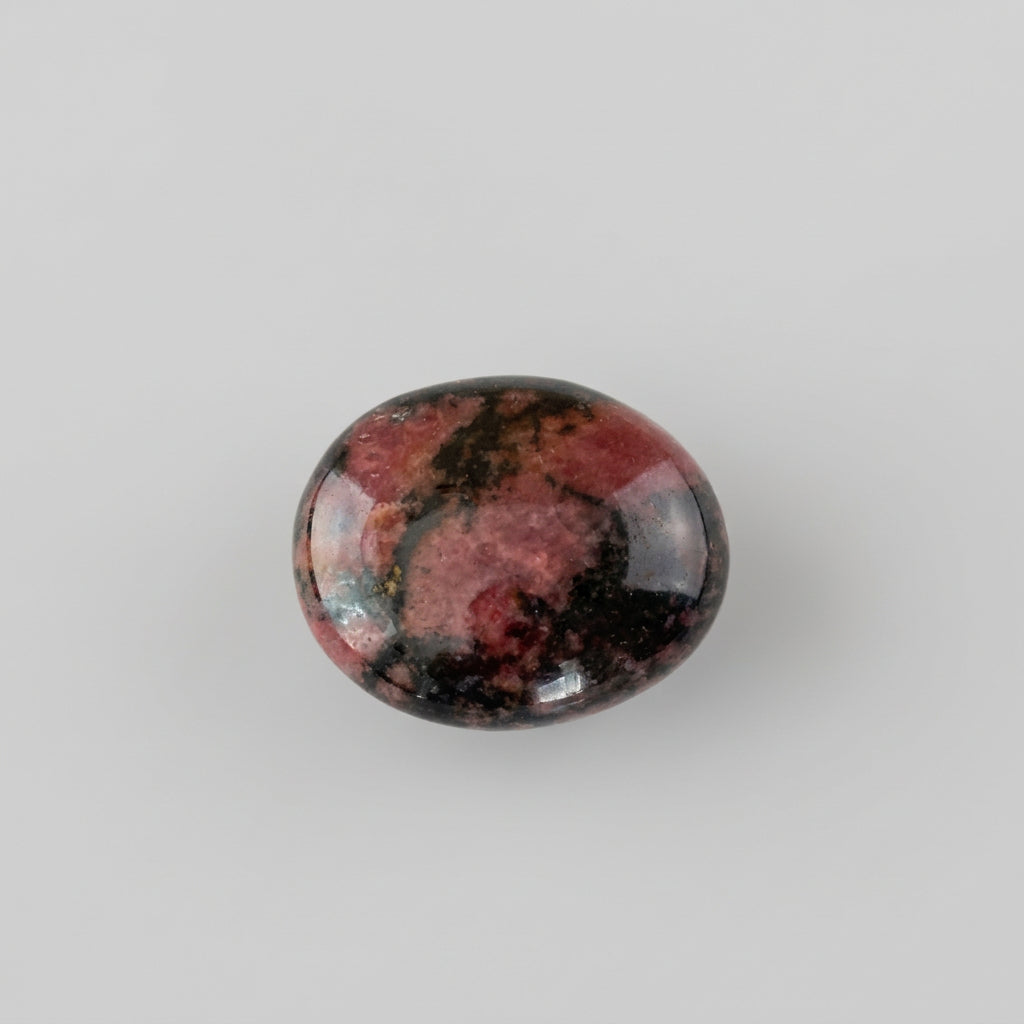 Rhodonite gemstone featuring distinctive pink and black patterns, showcased in the J.W.H. Designs gemstone collection.