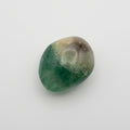 Fluorite gemstone featuring natural bands of purple, green and translucent hues, showcased in the J.W.H. Designs gemstone collection.